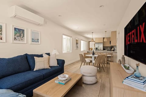 Open concept living room, dining area with breakfast bar and fully stocked kitchen.