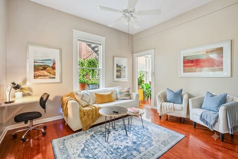 Cozy living room with comfortable seating, a dedicated workspace, and a relaxing atmosphere—perfect for unwinding or getting a little work done.