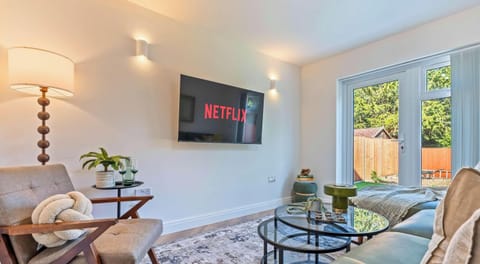 Spacious lounge with comfortable seating and garden views.