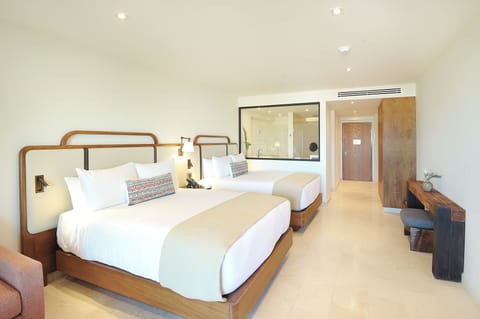 Settle into crisp linens in a bright, airy retreat.