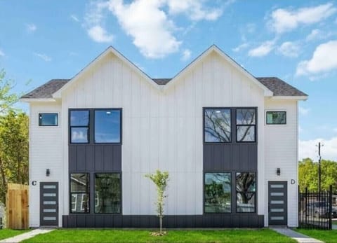 Modern duplex with bold curb appeal, large windows, and a fresh sleek design