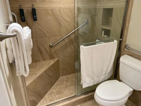 Spa-like bathroom with glass walk-in shower and built-in bench