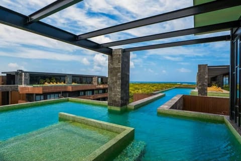 Soak in breathtaking jungle views from this stunning rooftop infinity pool, pure Tulum vibes.