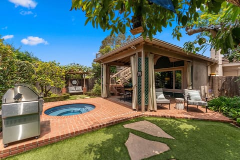 Private backyard oasis with spa, grill, and covered outdoor lounge