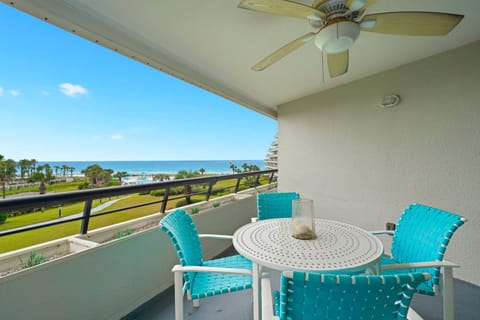 Relax on the private Gulf front balcony with comfortable seating and beautiful views of the pool, beach, and emerald waters.
