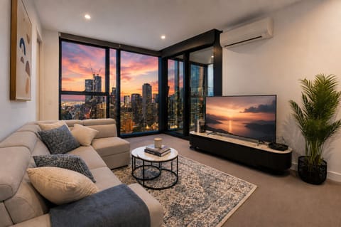 Modern city-view lounge with floor-to-ceiling windows and stunning sunset skyline