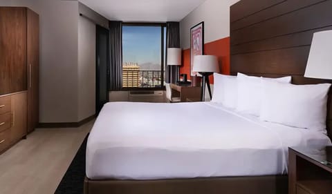 Unwind in crisp linens with calming city-view light.