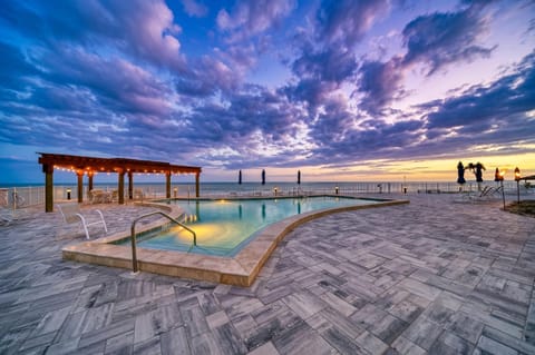 Oceanfront pool & hot tub with stunning sunset views