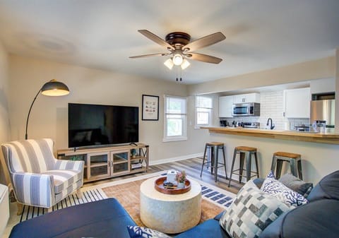 pen living space with a 65" Roku TV, comfy sectional, and accent chair. The kitchen’s high-top counter seats three, creating a welcoming spot to dine or relax while meals are prepared.
