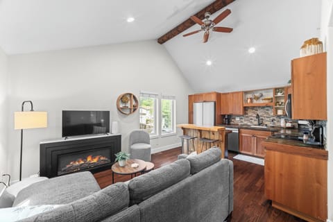 Open living space with a fireplace, dining area, and kitchen made for gathering.