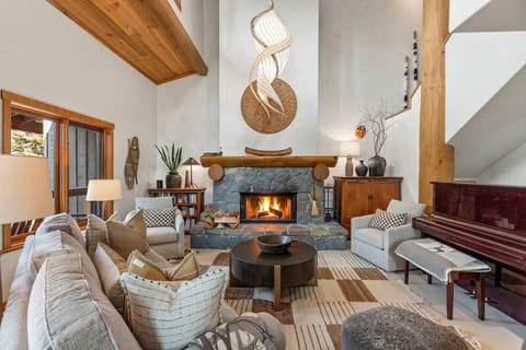 - Warm up by the glowing stone fireplace in this inviting great room - Vaulted ceilings and mountain décor create a true alpine ambiance - Gather for movie nights or fireside chats in this cozy living space