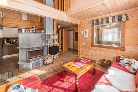 Living area with a cozy fireplace, television, and comfortable seating.