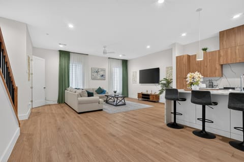 Bright open living space with modern kitchen island and stylish lounge area