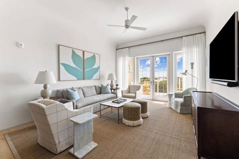Gather for movie nights beside bright windows and balcony doors.