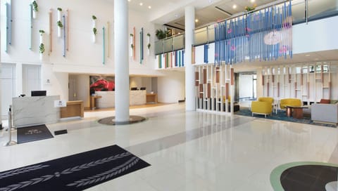 Arrive to a soaring, sunlit lobby with modern elegance.
