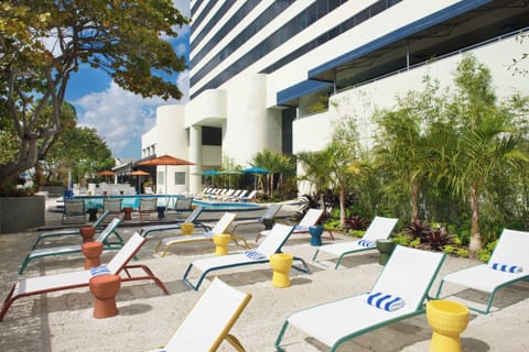 Dive into a sparkling pool surrounded by sun loungers.