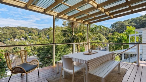 Relax on the covered balcony surrounded by lush North Avoca greenery