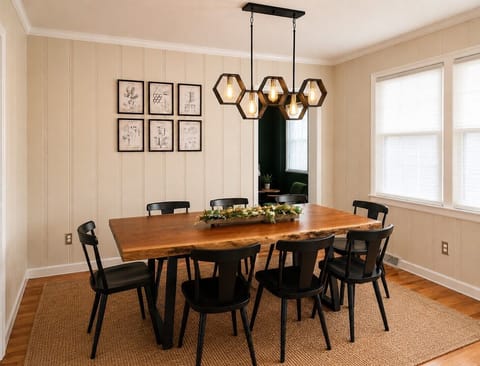 Bright dining room with seating for 8 and modern designer lighting