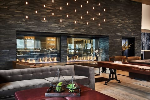Sip a nightcap beside the sleek, flickering linear fireplace