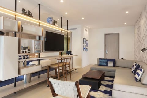 Lounge comfortably beside designer lighting and coastal textures.