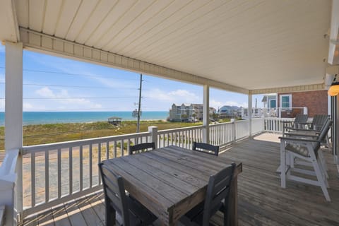 Experience ultimate outdoor living on this massive covered deck, offering shaded alfresco dining, elevated seating, and sweeping oceanfront views.