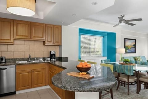 Bright open kitchen with granite counters and cheerful dining nook