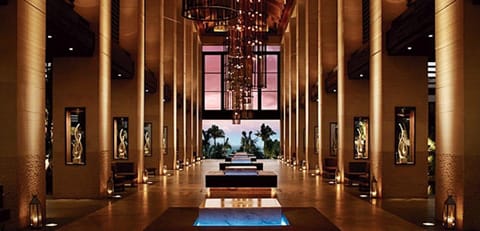 Grand open-air lobby with soaring ceilings and luxe resort ambiance