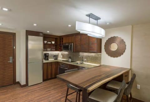 Modern kitchen with wood finishes, stainless appliances, and chic dining nook