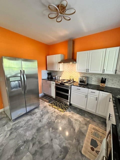 Fully equipped kitchen with a coffee bar and stainless steel appliances, First Floor