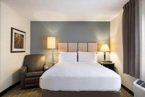 Unwind into crisp linens and soft, warm bedside glow.