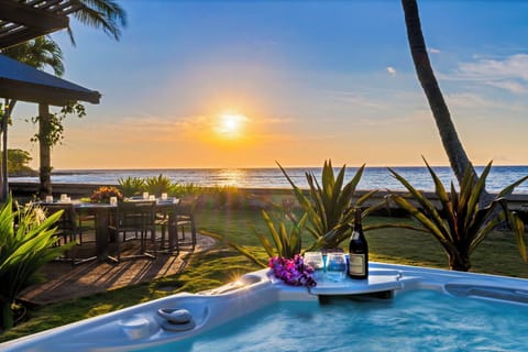 Ease into the hot tub with the sun melting into the Pacific out front.