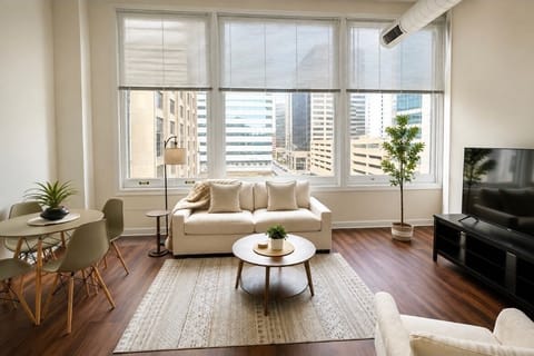Bright downtown living room with skyline views and stylish modern decor