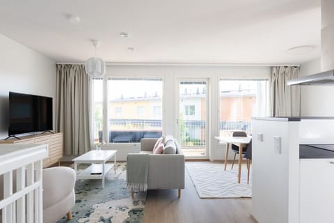 Living and dining space opening onto the glassed-in balcony, Padisentie 8 C 12