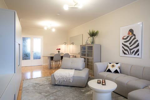 The heart of the apartment is the beautifully furnished living room with dining area