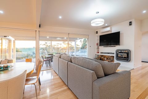 Whether you're catching up over coffee or unwinding after a day at the beach, the living area offers inviting comfort with ever-changing views beyond the windows.