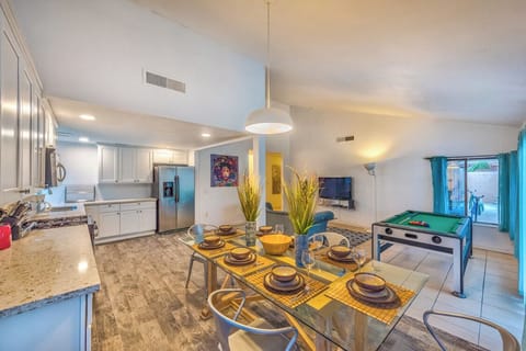 Open-concept kitchen, dining & game room with patio access