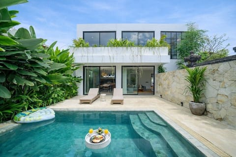 Outdoor Oasis: Relax poolside under the sun, surrounded by lush tropical greenery!