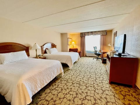 Wake up to soft daylight in your airy double-queen retreat.