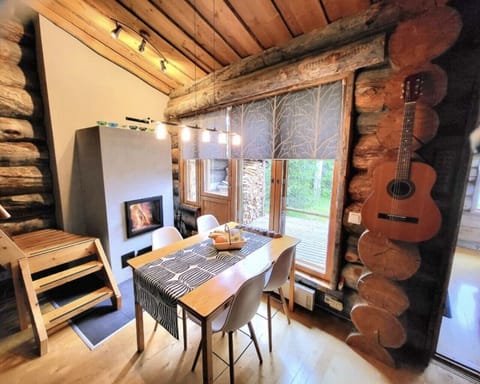 Dining area with a table and chairs for shared meals beside the window.