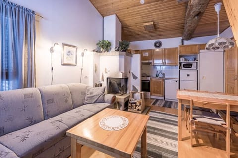 Open-plan living room and kitchen with a corner sofa, fireplace and dining table.