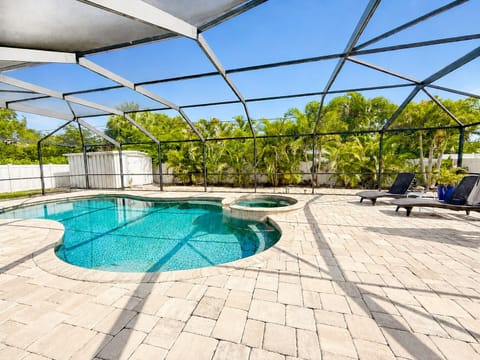 Private screened pool & spa with tropical views and sunny lounge space