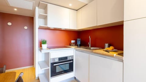 Kitchen area with cabinets, sink, and small appliances.