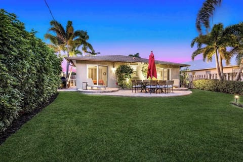 Evening Escape: Enjoy the peaceful backyard with outdoor dining and a cozy patio setting.