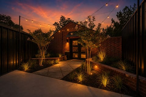 Charming private courtyard with string lights and a glowing sunset backdrop