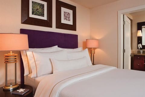 Cozy bedroom with plush linens, warm lighting, and stylish decor