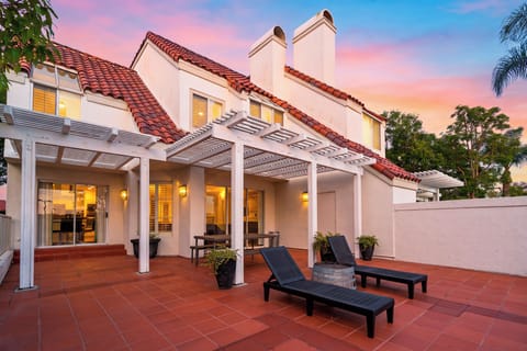 An inviting evening view of the home opening onto the spacious terrace.