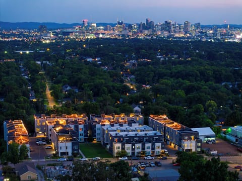 Golden hour over the community, skyline glowing in the distance