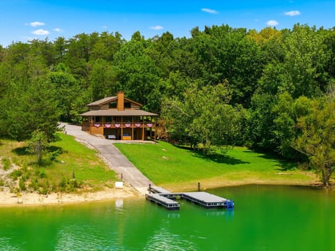 This charming lakefront property sits nestled among lush trees with direct water access and a private dock, offering a serene natural setting for summer escapes.