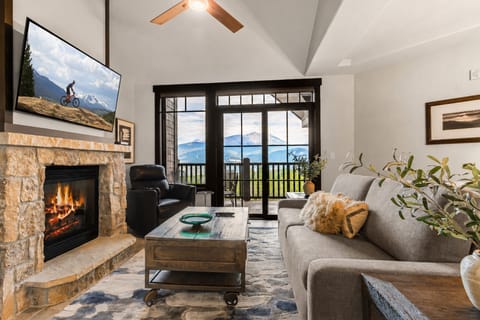 Unwind in your inviting living room, where a warm fireplace and mountain views create the perfect retreat after a day of adventure.