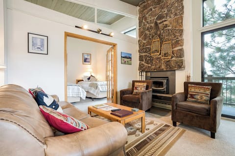 Unwind in your welcoming living room, where leather seating and a rustic stone fireplace create the perfect cozy retreat after a day of adventure.